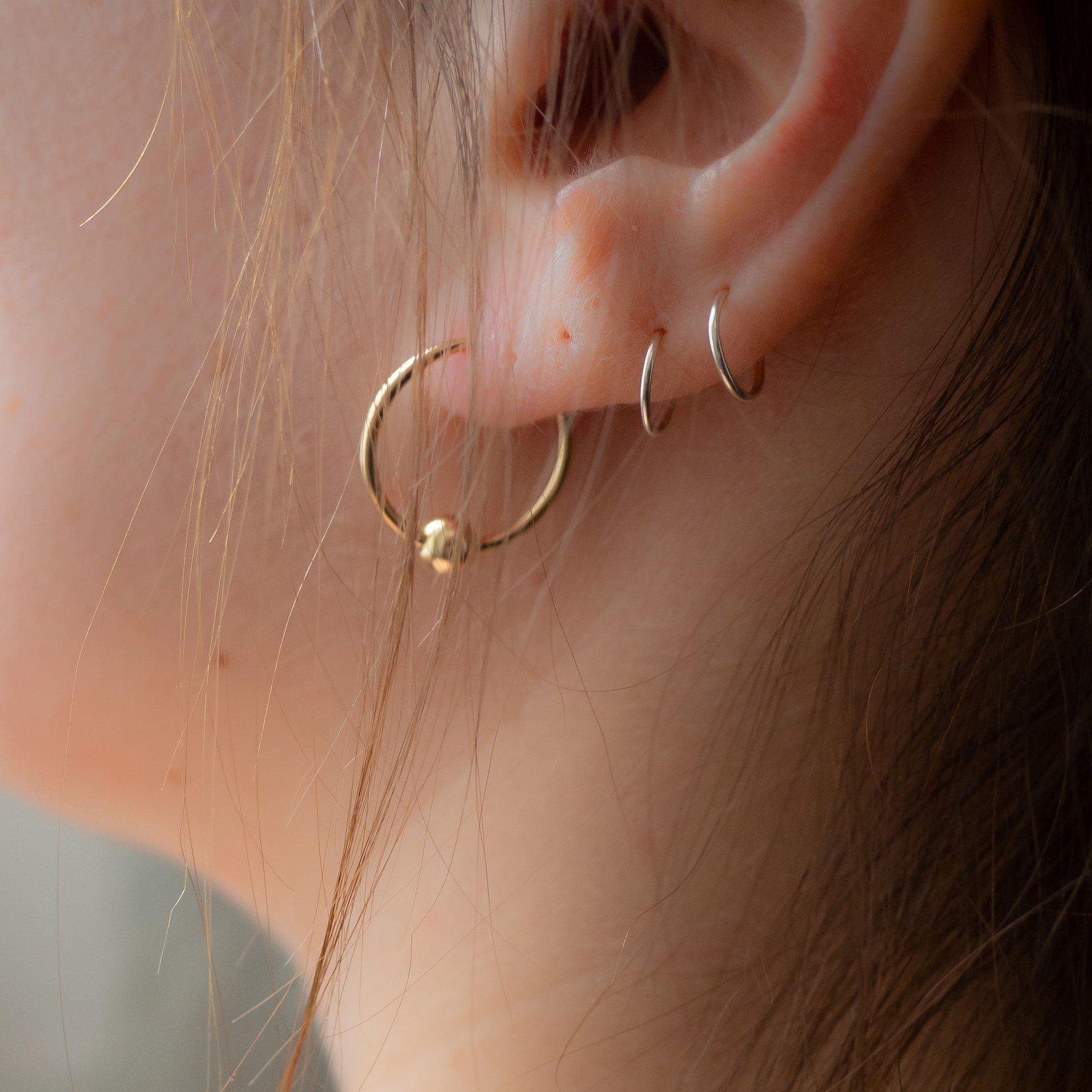 Goldfarbene Ohrringe mit Perlen, Fake-Piercing-Design